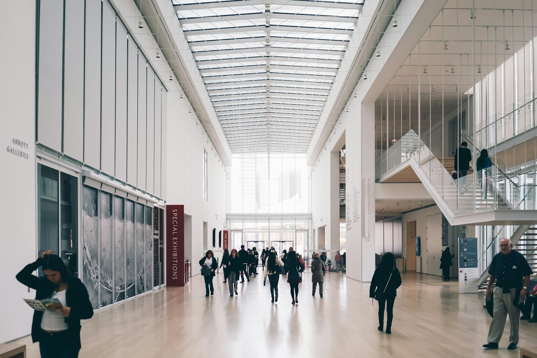 people along hallway of concrete building